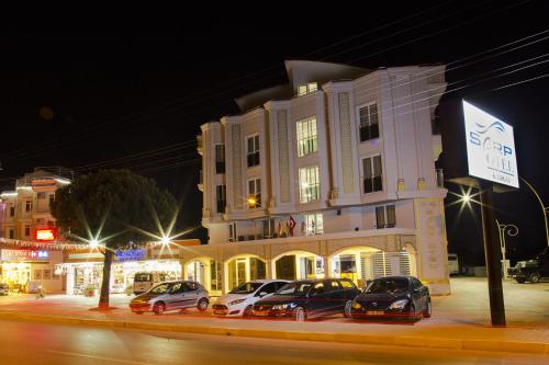 a large white building with cars parked in front of it at Sarp Hotel Kadriye in Belek