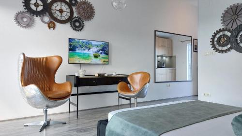 a bedroom with two chairs and a desk and a tv at Refresh Boutique Apartments in Vodice