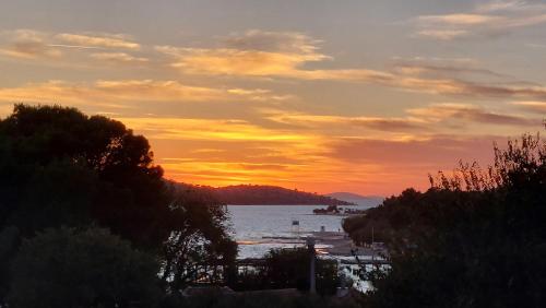 a sunset over a body of water with a beach at Refresh Boutique Apartments in Vodice