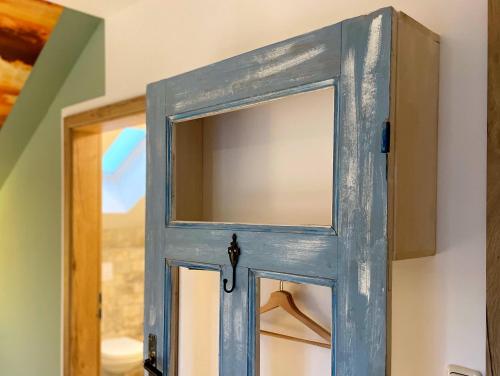 a blue door with a window in a room at Haus zwischen den Wehlen bei Büsum, 16 Personen in Westerdeichstrich