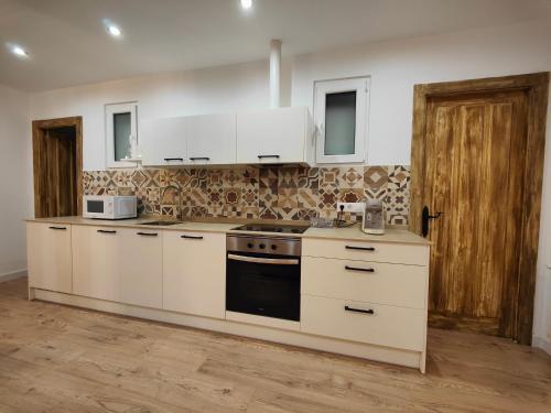 uma cozinha com armários brancos e um fogão em Apartamentos Santander 2 em Santander
