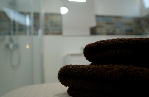 una pila de toallas sentadas sobre una mesa en VolcanoKite Apartments en Famara
