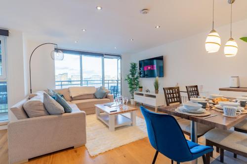 a living room with a couch and a table at Central Thames View 3BR by Sullivan Stays in London