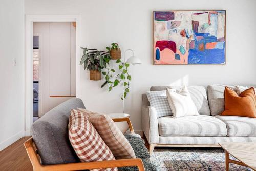 a living room with a couch and a table at Convenient luxury home, minutes to CBD + hospital in Launceston
