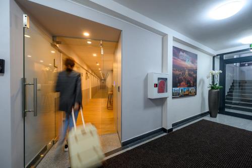 a woman walking down a hallway with shopping bags at LOCATION in Sofia
