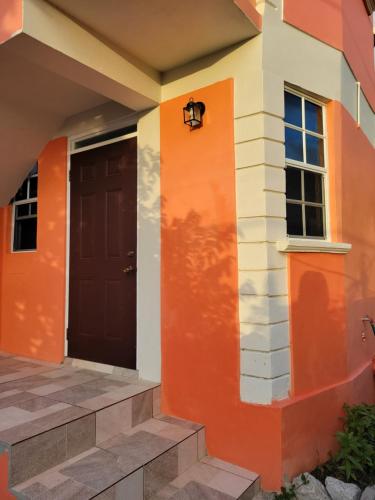 a front door of a house with an orange at KanXio's Apartment in Pointe Michel