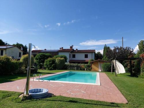 una piscina in un cortile con una casa di [Piscina Privata] Tiger Home, Toscana a Capannori