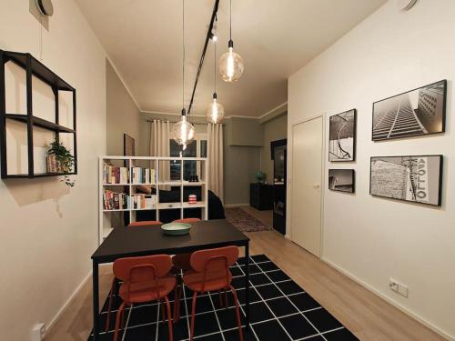 a living room with a table and two chairs at Brooms - Newly renovated central studio apartment in Pietarsaari