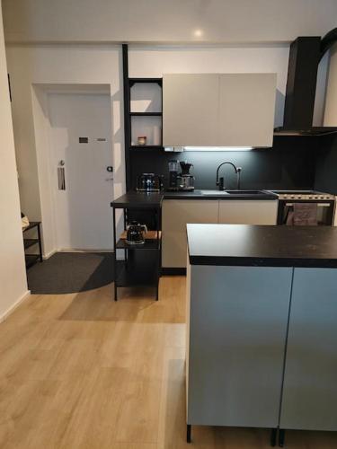 a kitchen with a sink and a counter top at Brooms - Newly renovated central studio apartment in Pietarsaari