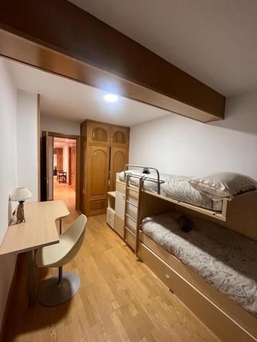a room with two bunk beds and a desk at SAPORO ELITE in Sierra Nevada