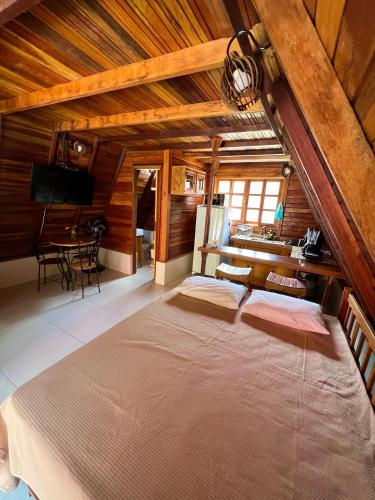 a bedroom with a large bed in a room at Chalés de Lençóis in Lençóis