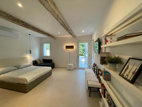 a bedroom with a bed and a living room at Due Di Tutto in Ferrara