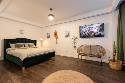 um quarto com uma cama e uma cadeira em Ultra central apartment em Baia Mare