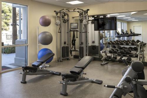 a gym with cardio equipment and tread machines at Costa Mesa Marriott in Costa Mesa