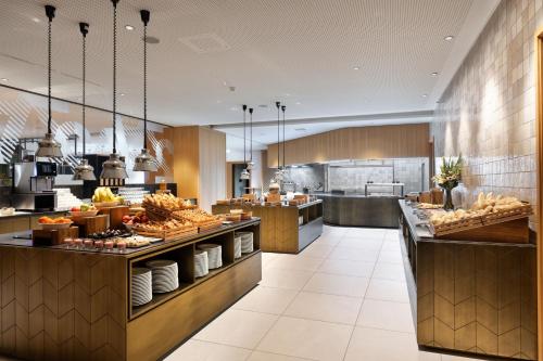 a restaurant with a buffet line with food at Four Points by Sheraton Ljubljana Mons in Ljubljana