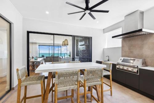 a kitchen with a table and chairs and a dining room at Seamist On Seagull WiFi in Hayborough