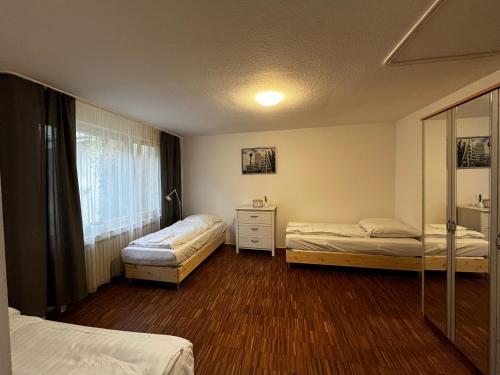 1 dormitorio con 2 camas y ventana en Volksgarten Residence, en Düsseldorf