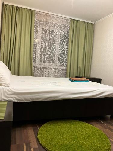 a bed in a room with a green curtain at Elena in Rivne