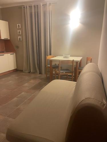 a kitchen and dining room with a table and a bed at Appartamento in centro Paese in Frabosa Soprana