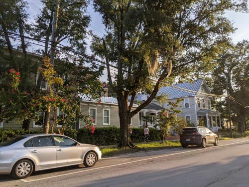 two cars parked on the side of a street with houses at The Craft House in Wilmington