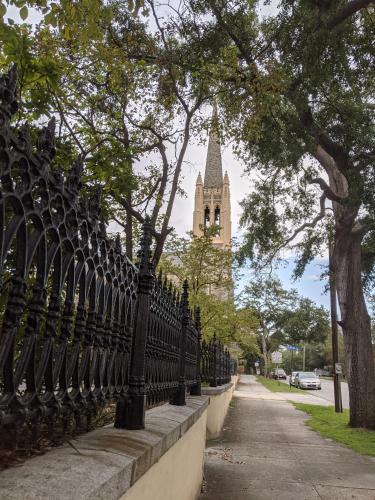 a black fence with a clock tower in the background at The Craft House in Wilmington