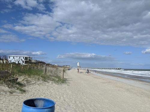 a beach with a trash can and people on it at The Craft House in Wilmington