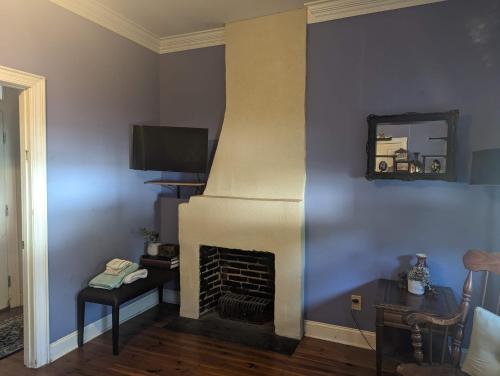 a living room with a fireplace with a mirror at The Craft House in Wilmington