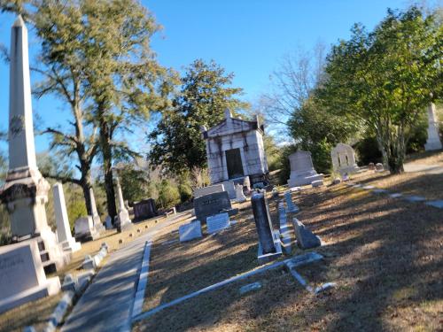 a cemetery with a small building in the grass at The Craft House in Wilmington