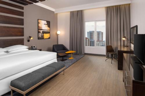 a hotel room with a bed and a tv at Four Points by Sheraton Lagos in Lagos