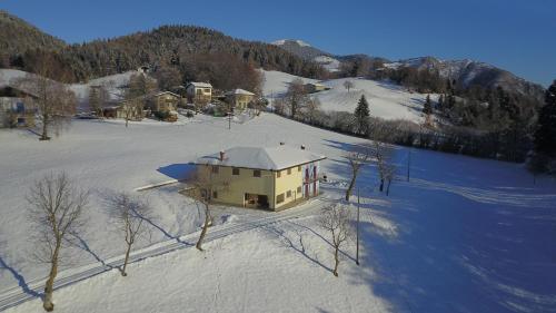 an aerial view of a house in the snow at Villa Glory Mountain Lake Iseo Hospitality in Bossico