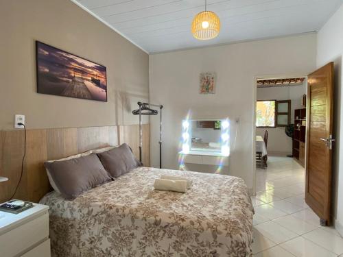 a bedroom with a bed with a laptop on it at Casa Paraiso de Sonho Verde in Paripueira