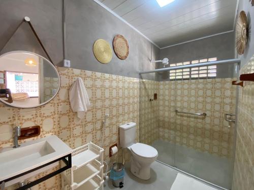 a bathroom with a toilet and a sink and a mirror at Casa Paraiso de Sonho Verde in Paripueira