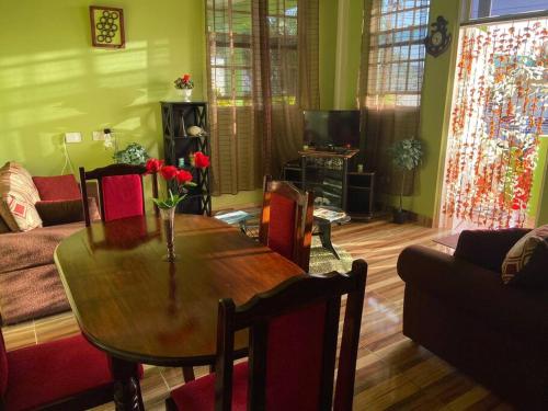 a living room with a table and a couch at Dangleben’s Apartment in Pointe Michel