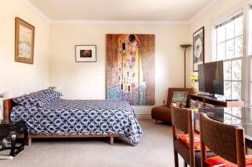 a bedroom with a bed and a living room at Free Parking on a Private St., Minutes to Georgetown, MedStar Hospital, Georgetown University and more in Washington, D.C.