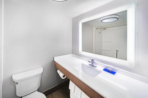 a white bathroom with a sink and a mirror at Holiday Inn Express El Paso-Central, an IHG Hotel in El Paso