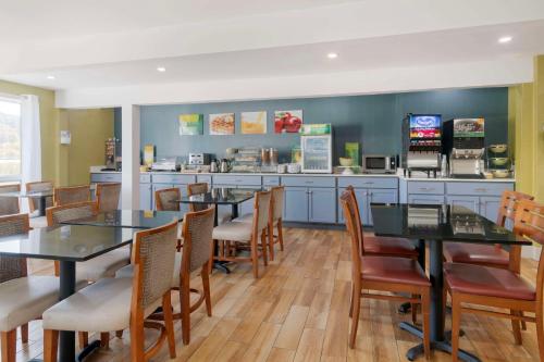 a restaurant with tables and chairs and a counter at Quality Inn Lebanon - Hanover in Lebanon