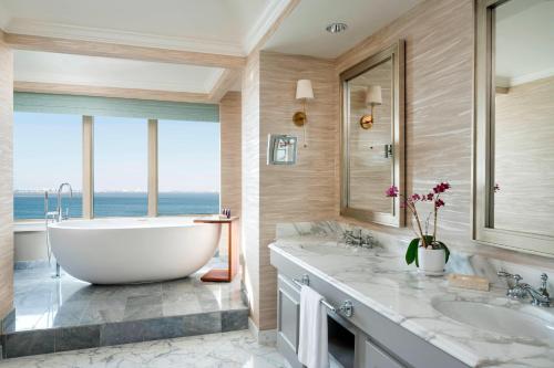 a bathroom with a large tub and two sinks at The Ritz-Carlton, Sarasota in Sarasota