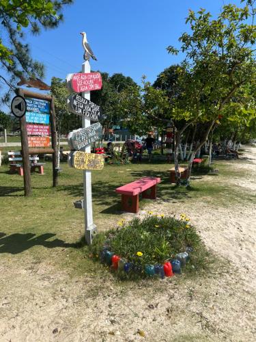 a street sign with signs in a park at Suite 3- Praia bonita Hospedagem,agora com ar condicionado in São Francisco do Sul