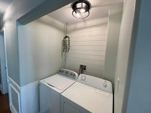 a laundry room with a white washer and a light at Fabulous 4BR only 1.5 blocks to the beach! in Wildwood