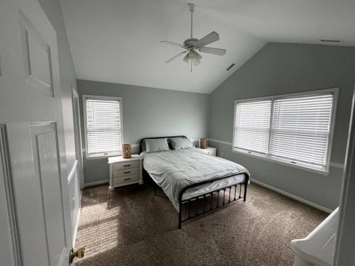 a bedroom with a bed and a ceiling fan at Fabulous 4BR only 1.5 blocks to the beach! in Wildwood