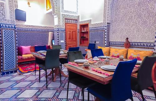 a dining room with a table and chairs at Riad Dar Lalj Fes in Fez
