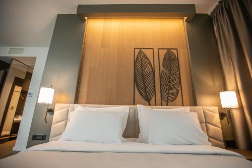 a bedroom with a large bed with two white pillows at The Hunter's Lodge Kamnik in Skopje