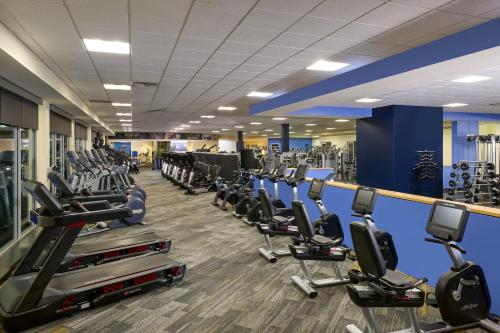 a gym with rows of treadmills and machines at Renaissance ClubSport Aliso Viejo Laguna Beach Hotel in Aliso Viejo