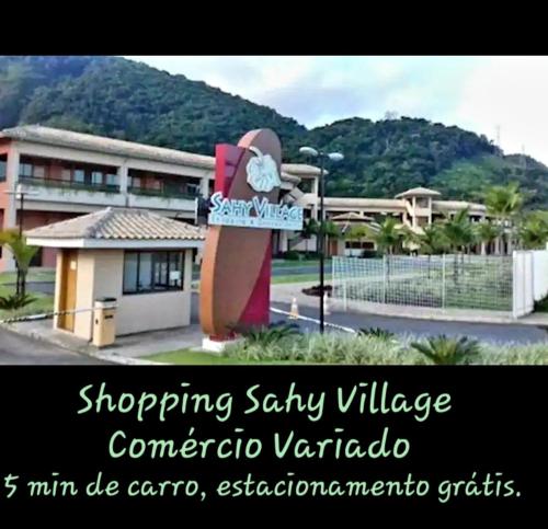 a sign in front of a building with shopping salty village connector vientoria at Meu Aconchego in Mangaratiba