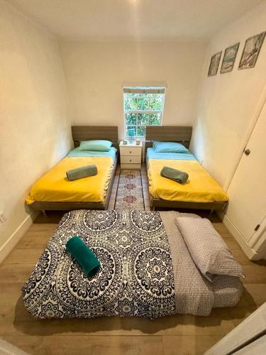 two beds in a small room with a window at Nice 2 Twin bedroom - Best central location in Miami - We have Drop off Service and Laundry for free!!!! in Miami