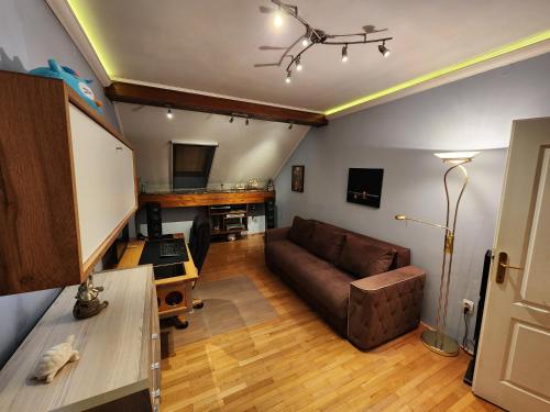 a living room with a couch and a table at Earth & Sky apartment in Sajmište