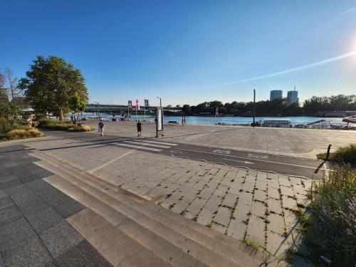 an empty parking lot next to a body of water at Earth & Sky apartment in Sajmište