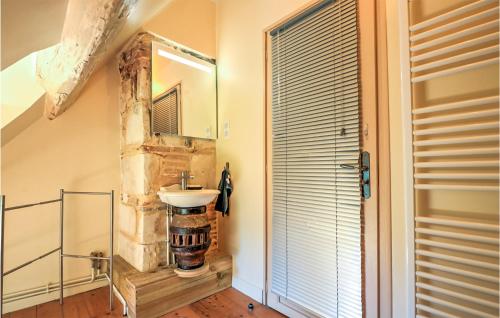 a bathroom with a sink and a mirror at Pet Friendly Home In Fontaine-la-louvet With Outdoor Swimming Pool in Thiberville