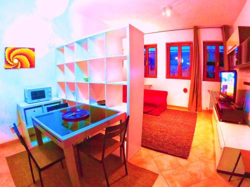 a living room with a table and a dining room at L' appartamento sul Naviglio in Milan