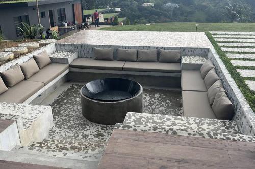 a bench and a fire pit in a yard at Luxurious Guest House on beautiful ranch in Medellín